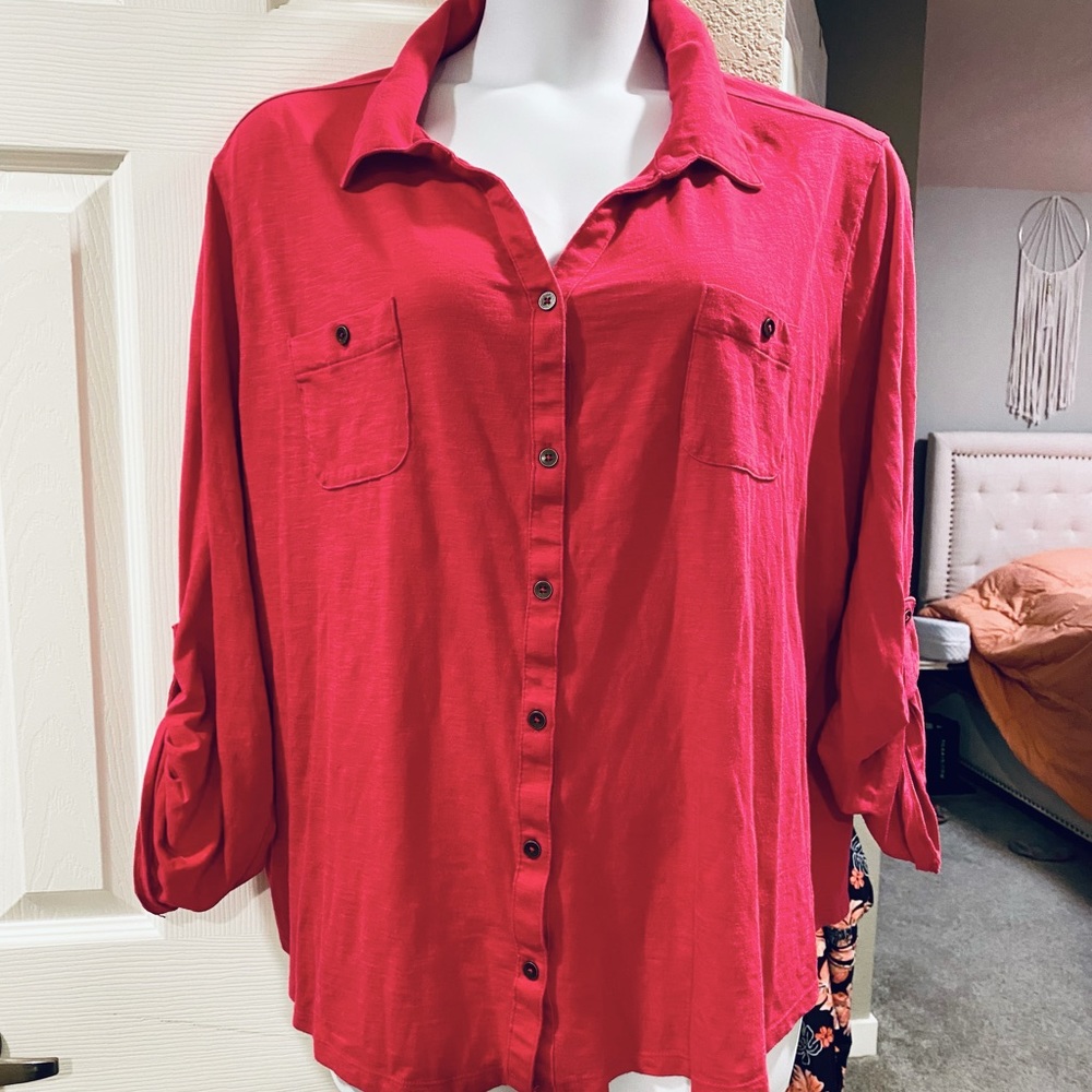 Button up top with pockets and adjustable sleeves.